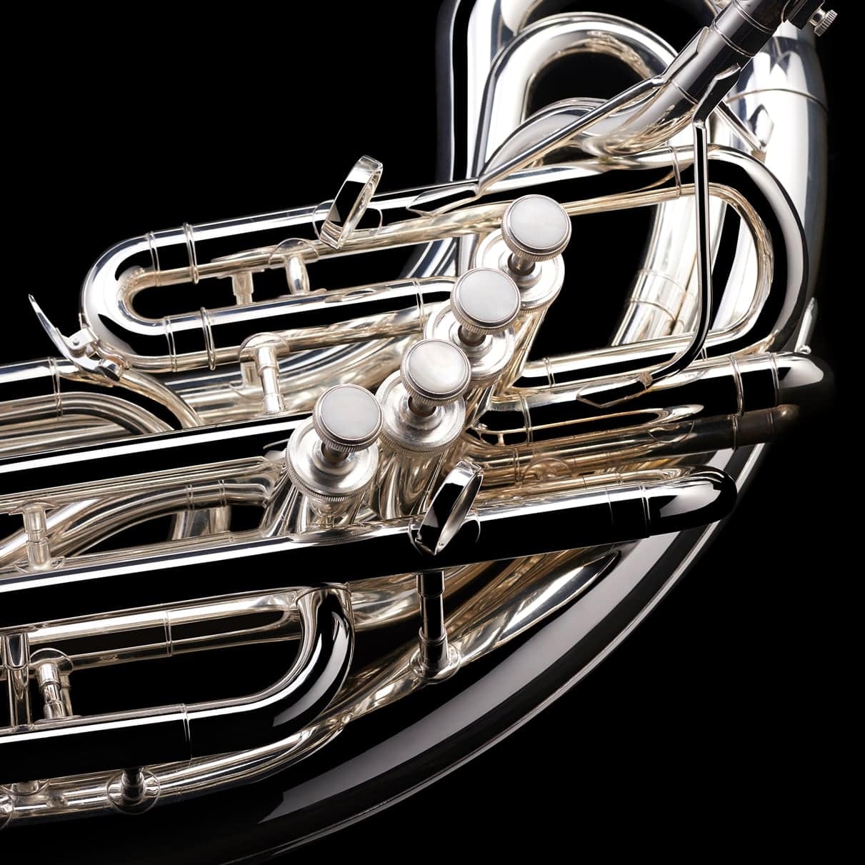 A close up image of the piston valves on a Eb Sousaphone (4-valve) from Wessex Tubas in silver