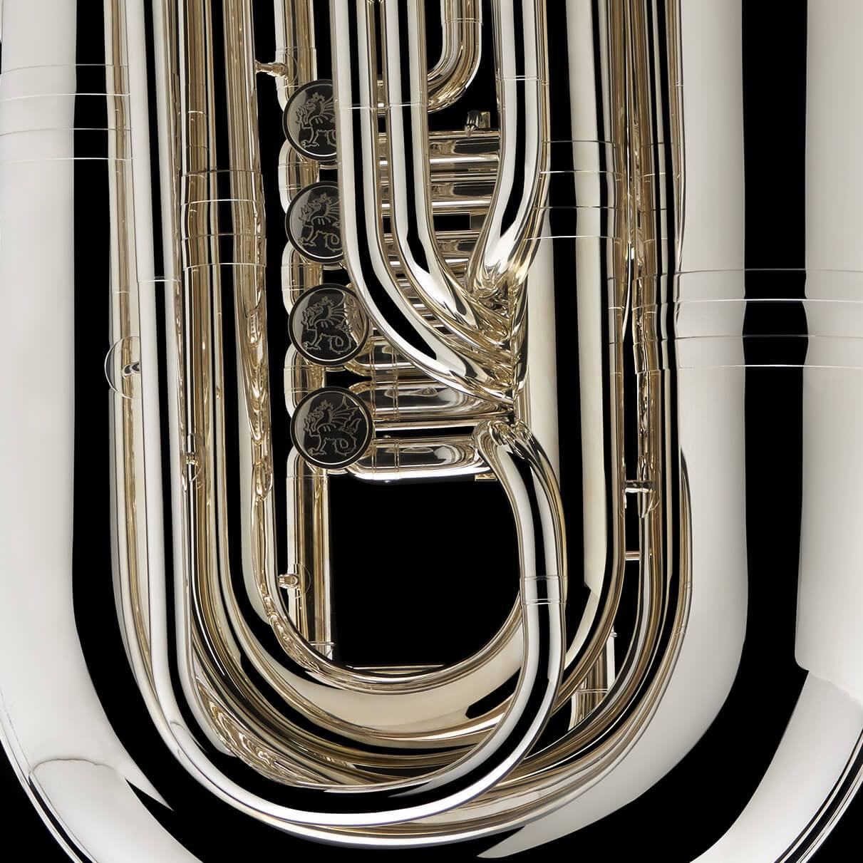 A close up image showing the detailed engravings on the valves of a BBb 6/4 Rotary tuba ‘Kaiser’ from Wessex Tubas